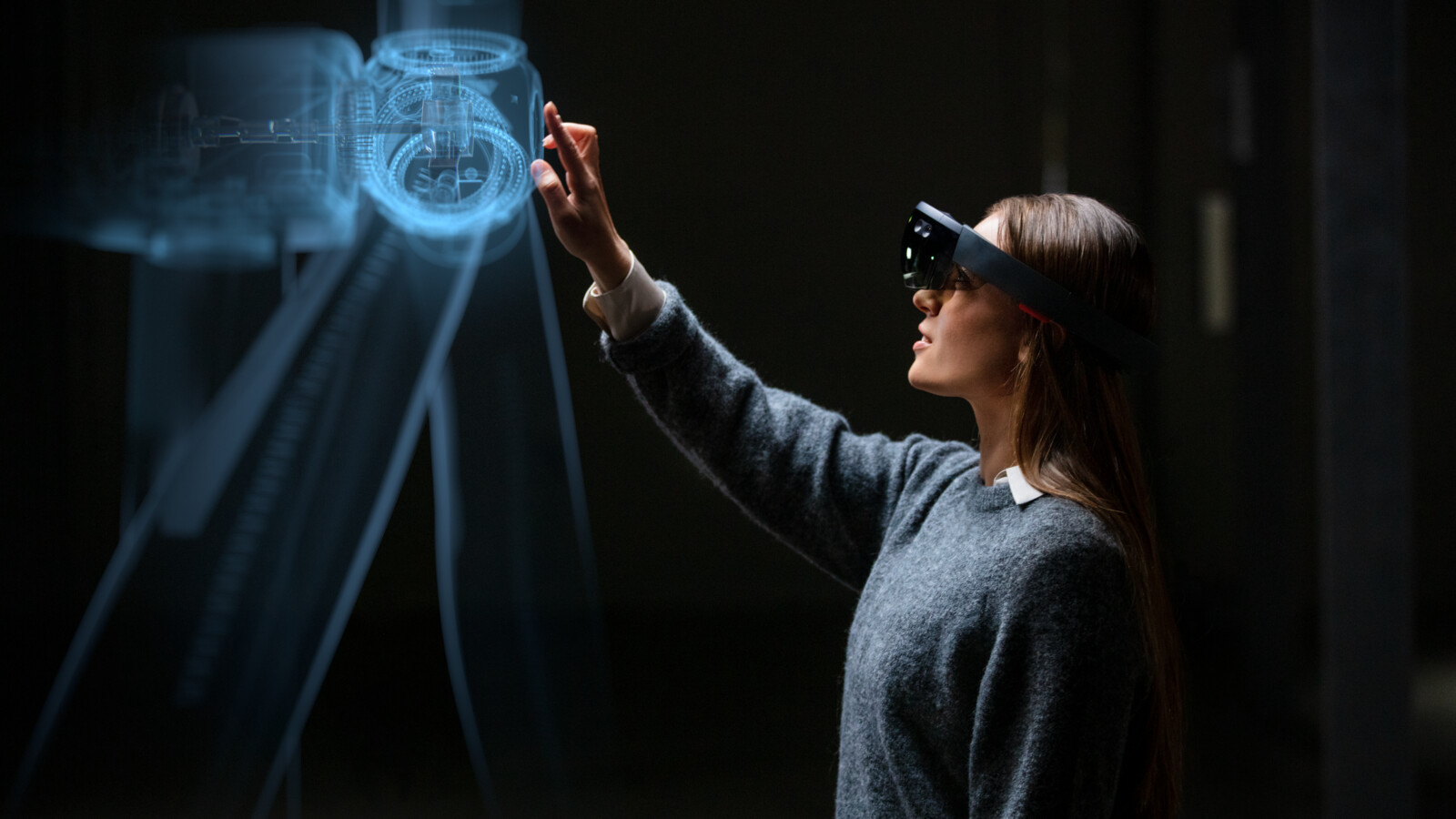 A female professional wearing hololense and working on digital twin technology