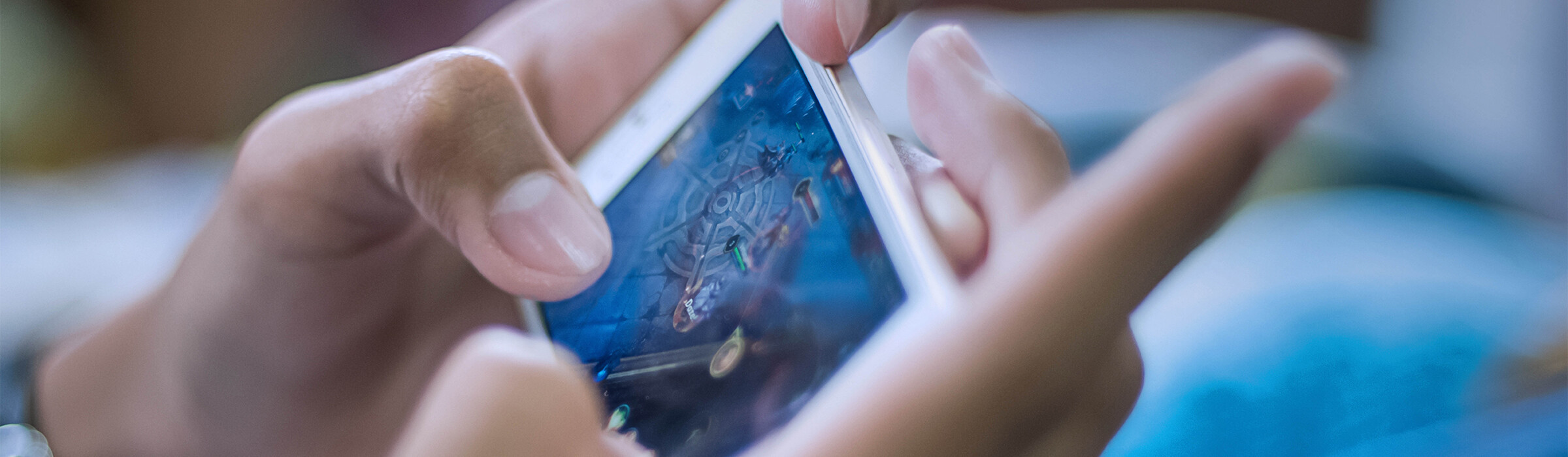 Hands holding a gaming device.