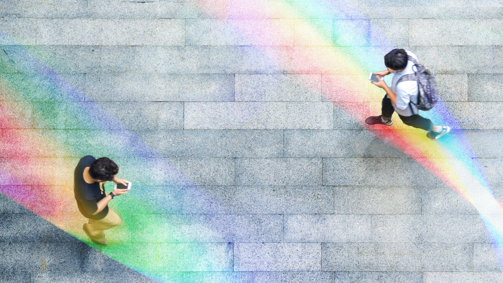 Persons in the street looking down in mobile telephones.