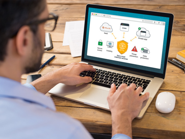 Man looking at web applications on laptop