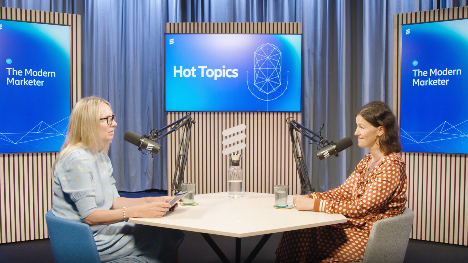 podcasters talking at a table