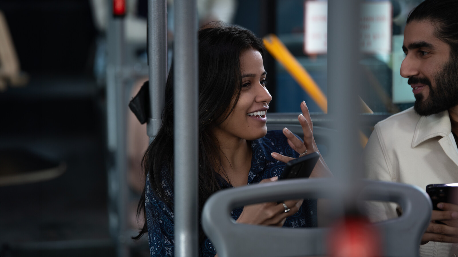 Two people on a bus, talking