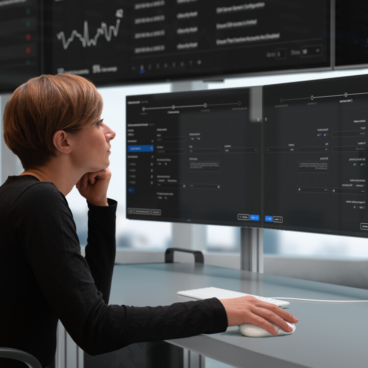 Persons monitoring computer screens.