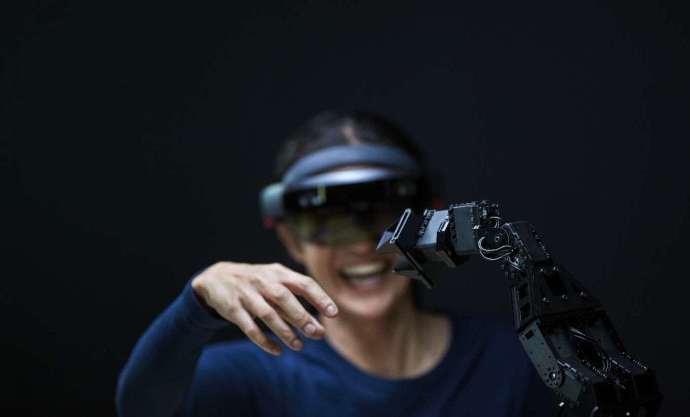 woman using AR with robot arm
