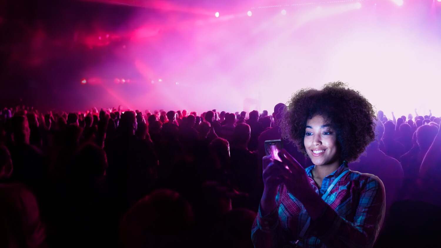 Woman using her mobile phone in an arena