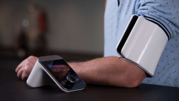 Person using heart monitoring e-health device at home