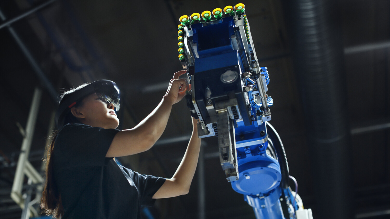 woman with robot in factory