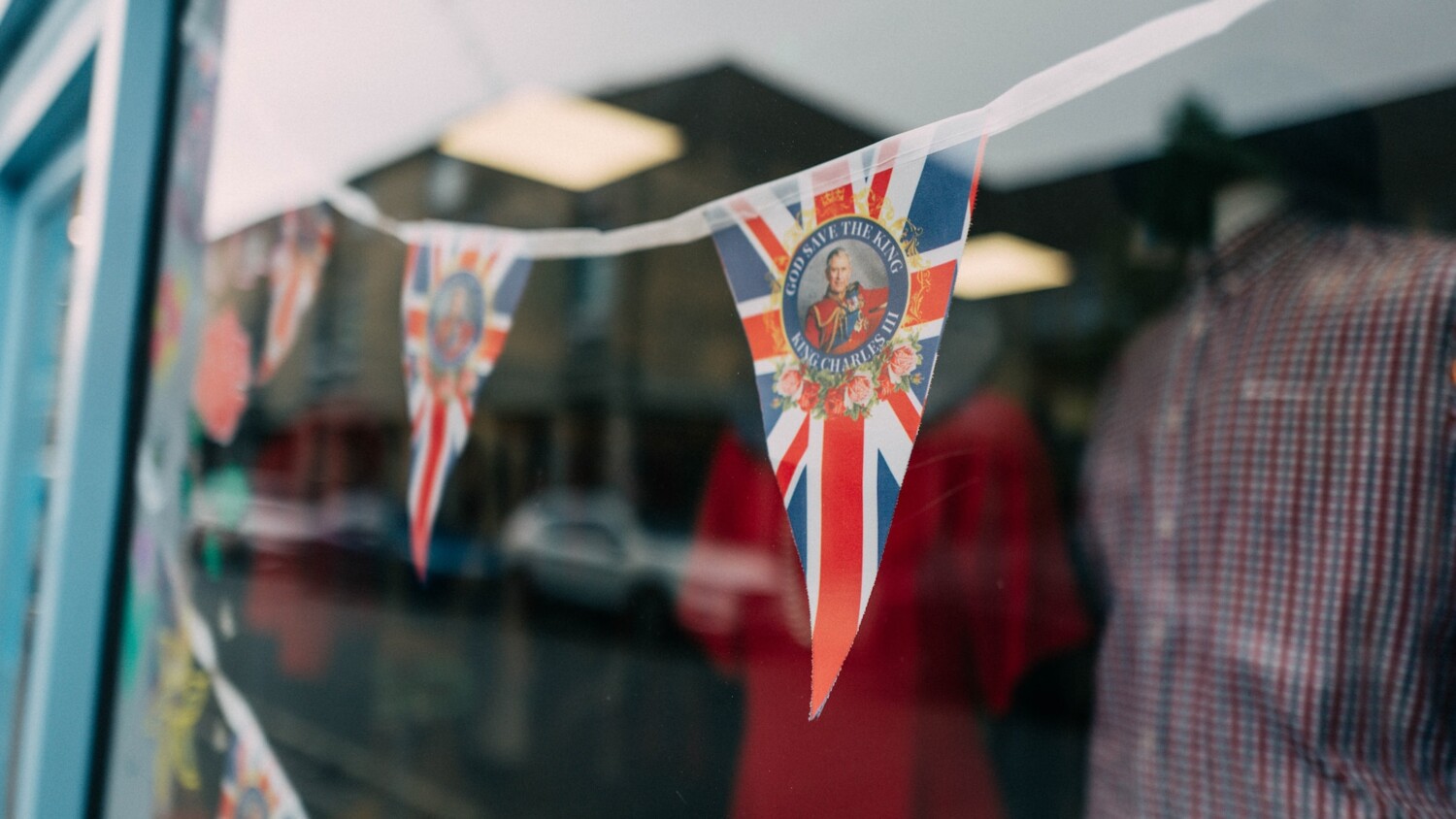 Decoration flags in a window during the King's coronation.