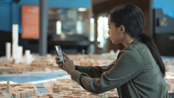 Woman with AR in front of city model