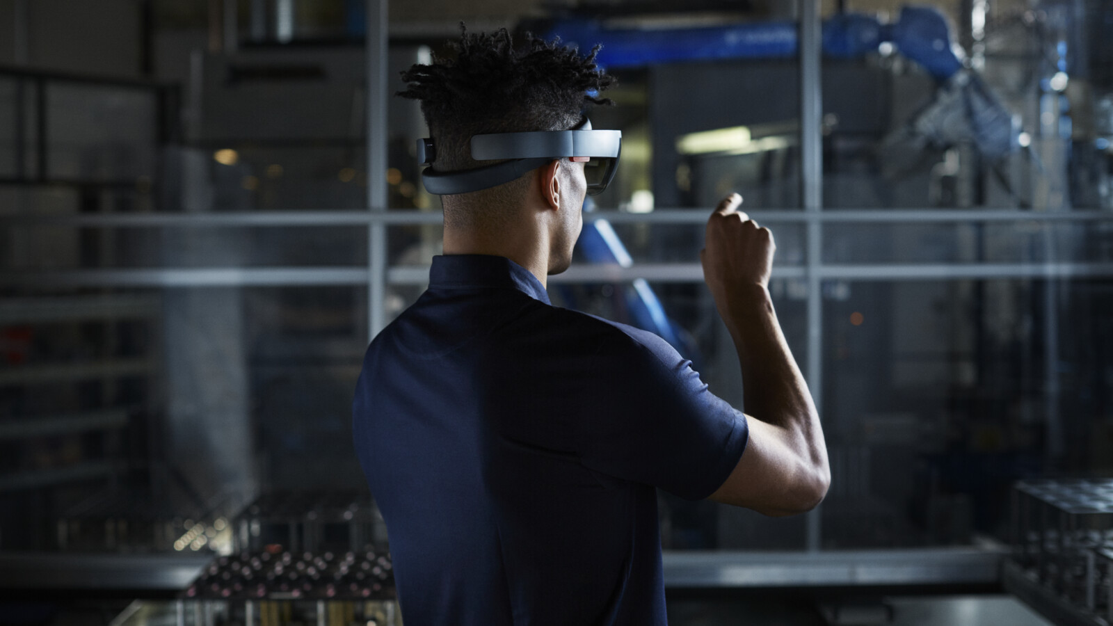 Engineer using AR glasses in factory.