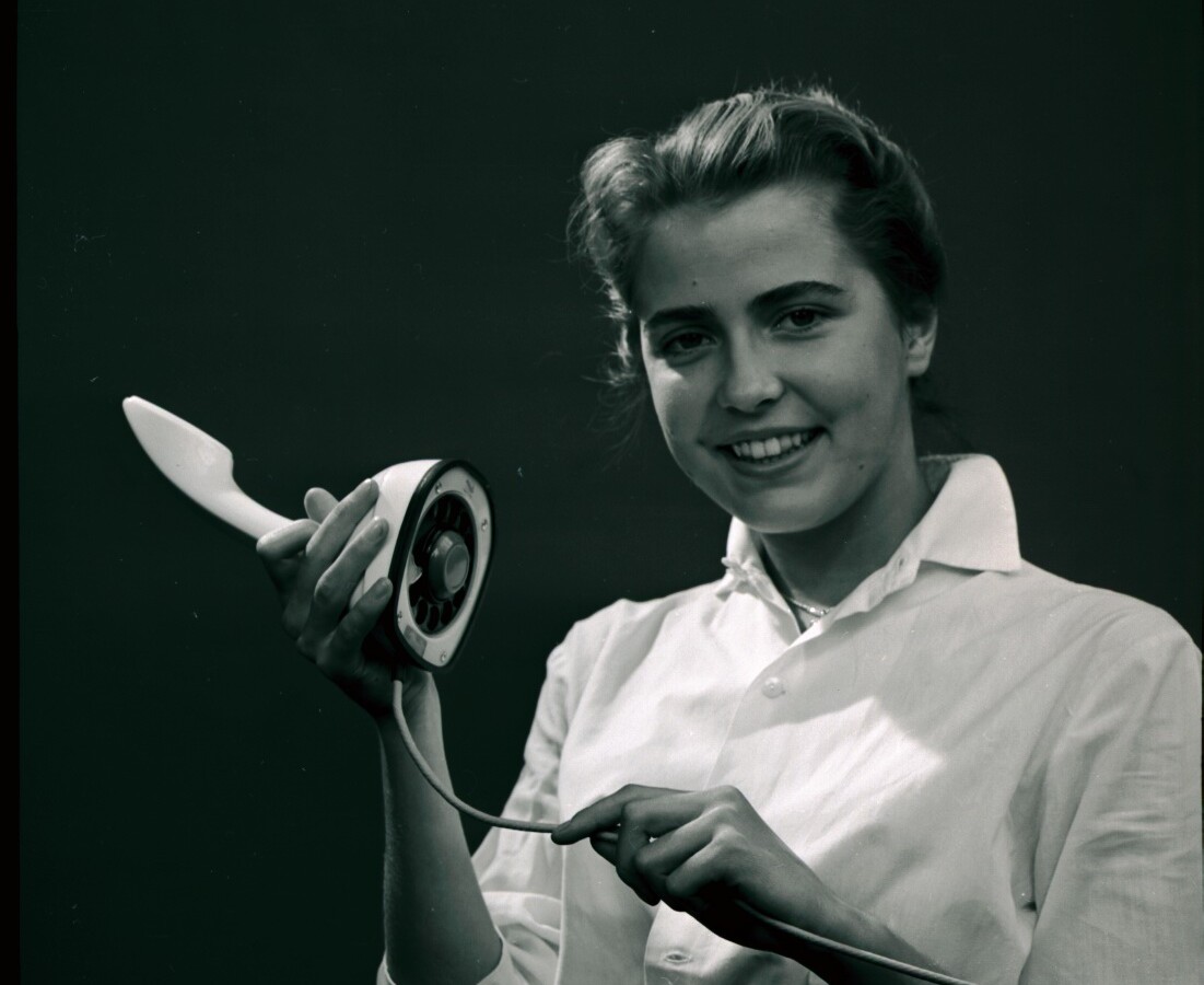 Girld holding an Ericofon, also know as the "Cobra" in 1957.