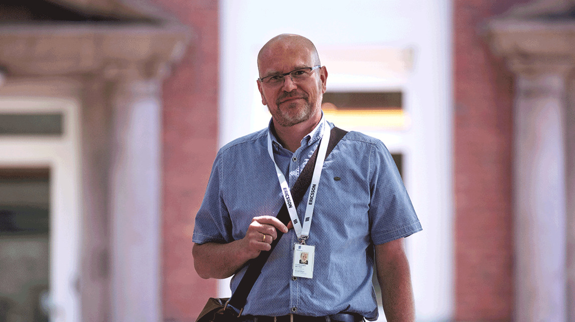 Christoph standing in front of a red brick building