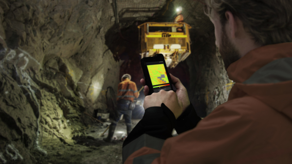 Mine worker using smartphone