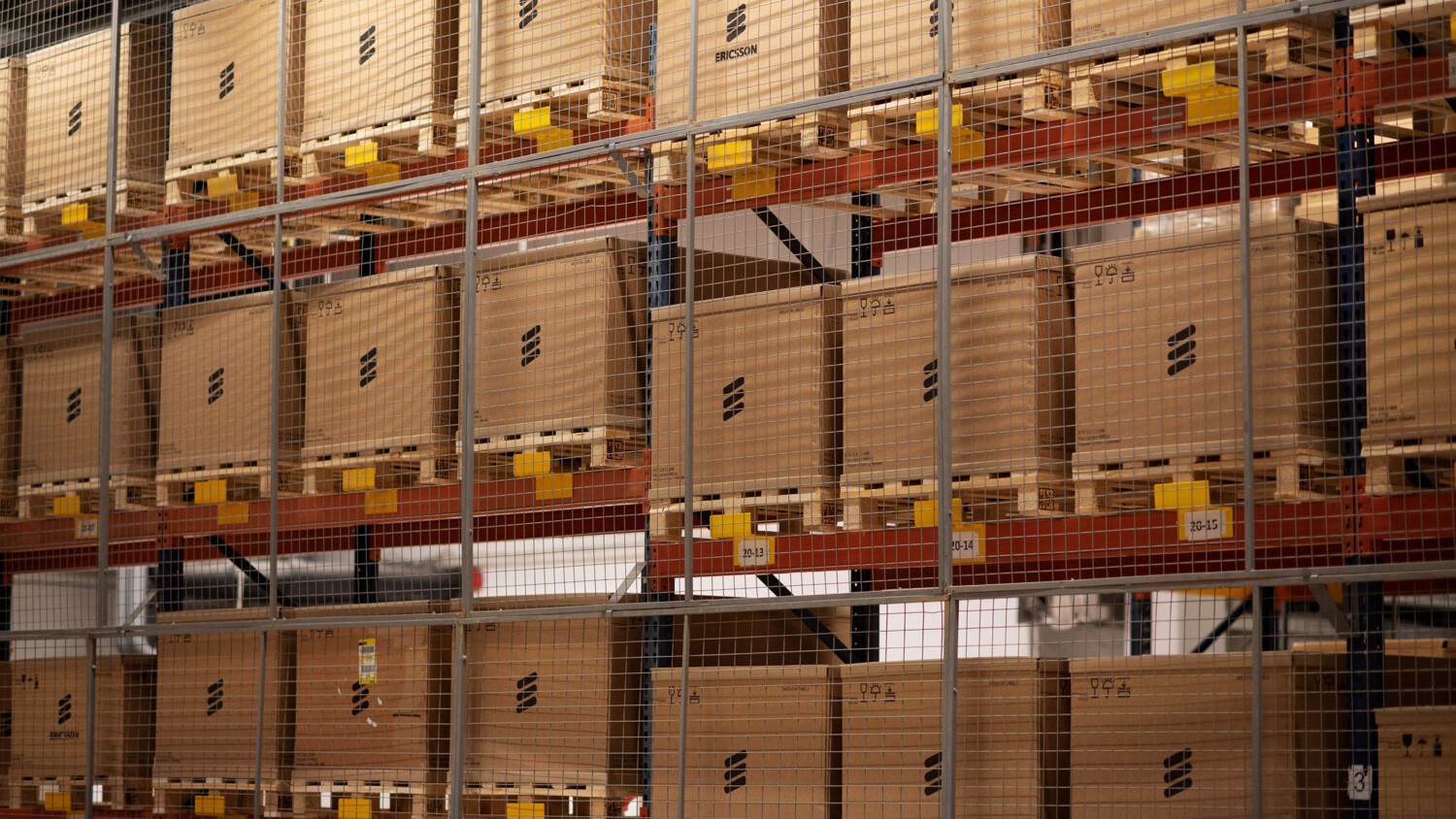 Radio equipment boxed and stacked in warehouse.