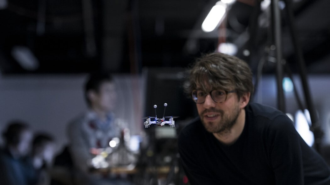 Man looking at a small drone.