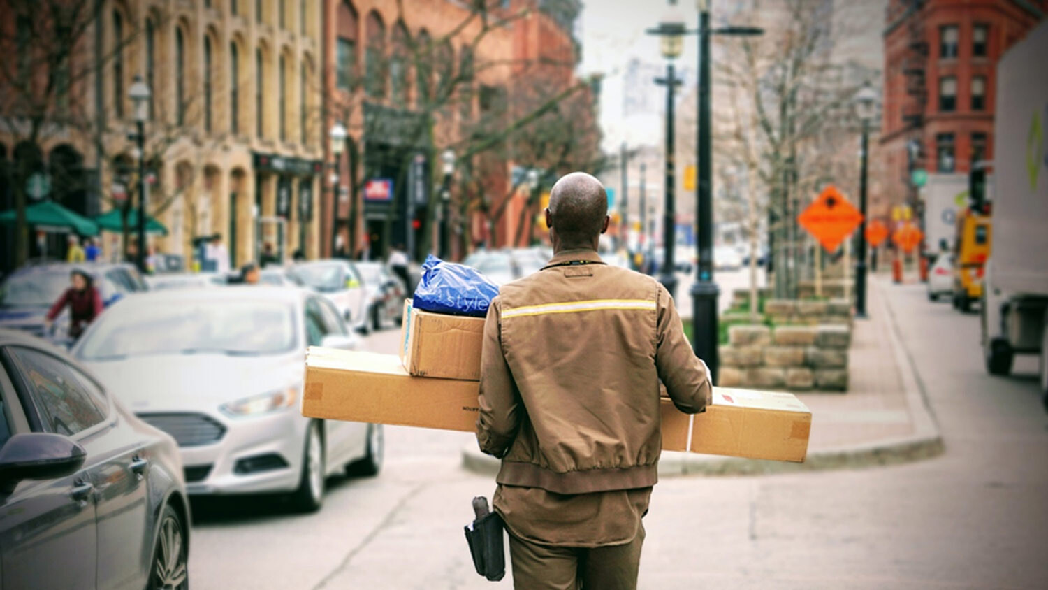 Person in the street carrying packages.