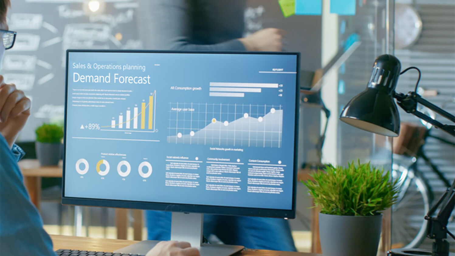 Person looking at a computer screen with graphs.