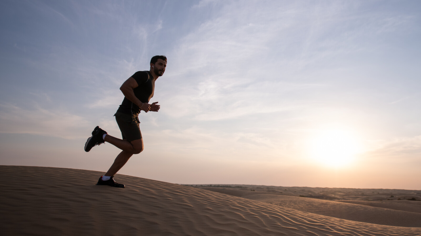 Man running in a desert.