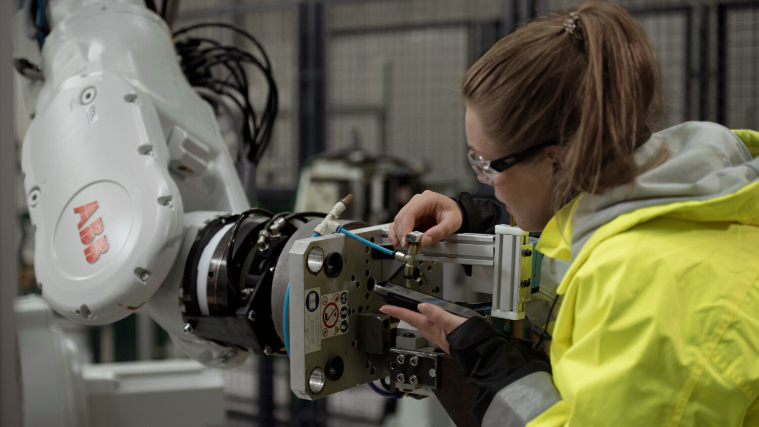 Technician working with IoT prototype robot in connected factory