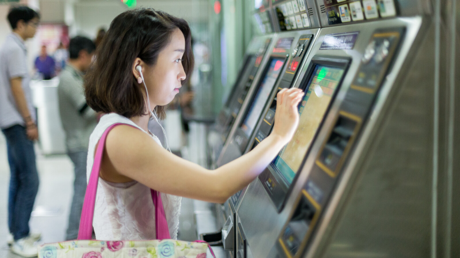 Woman buying subway ticket