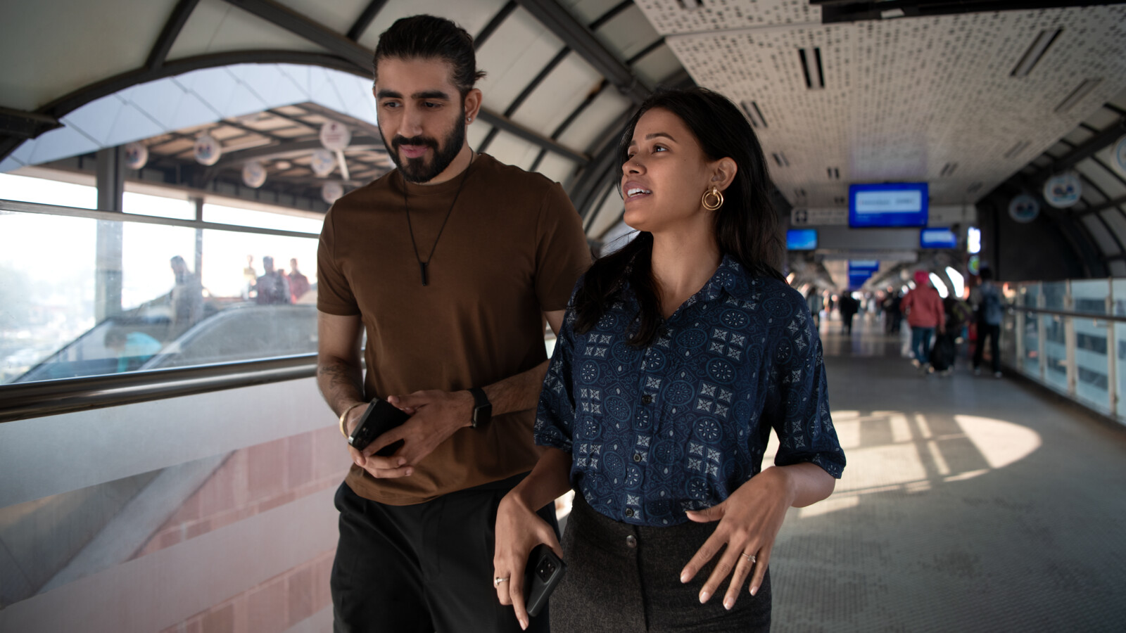 Two people at a train station