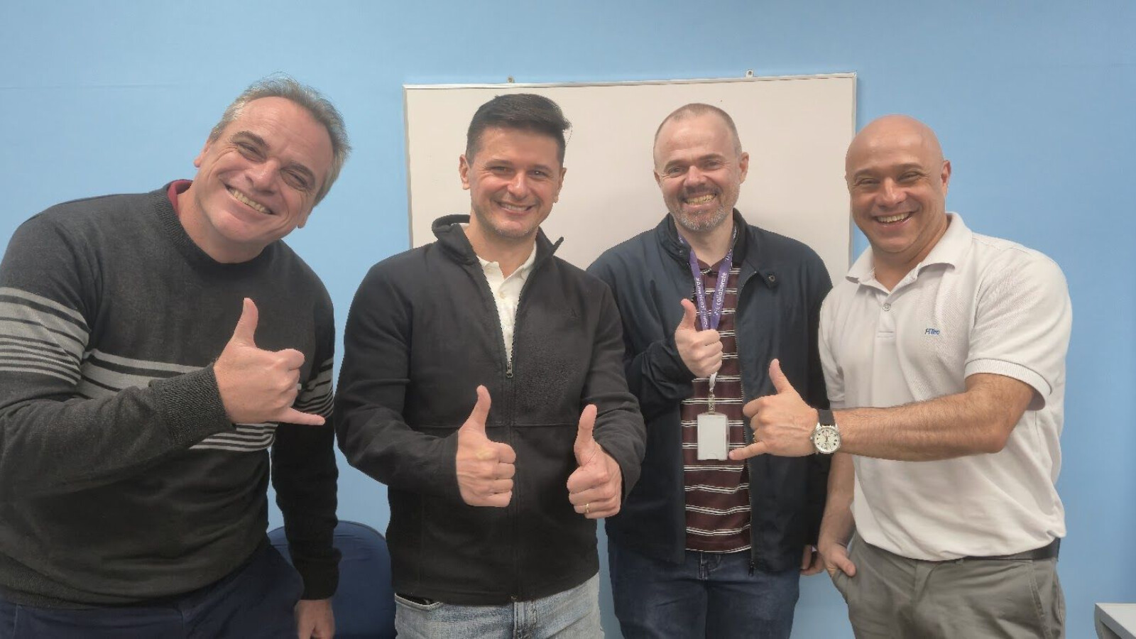 Carlos Flaminio and his team putting their thumbs up for the camera.