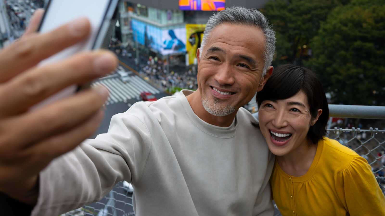 Man and woman taking selfie from rooftop