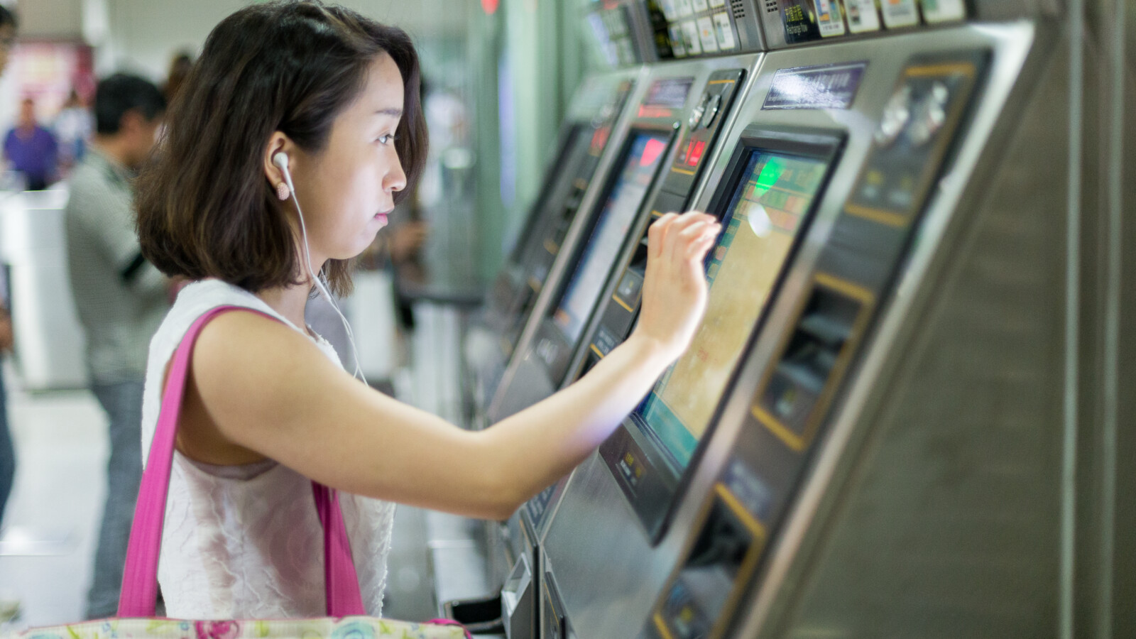 Woman buying subway ticket