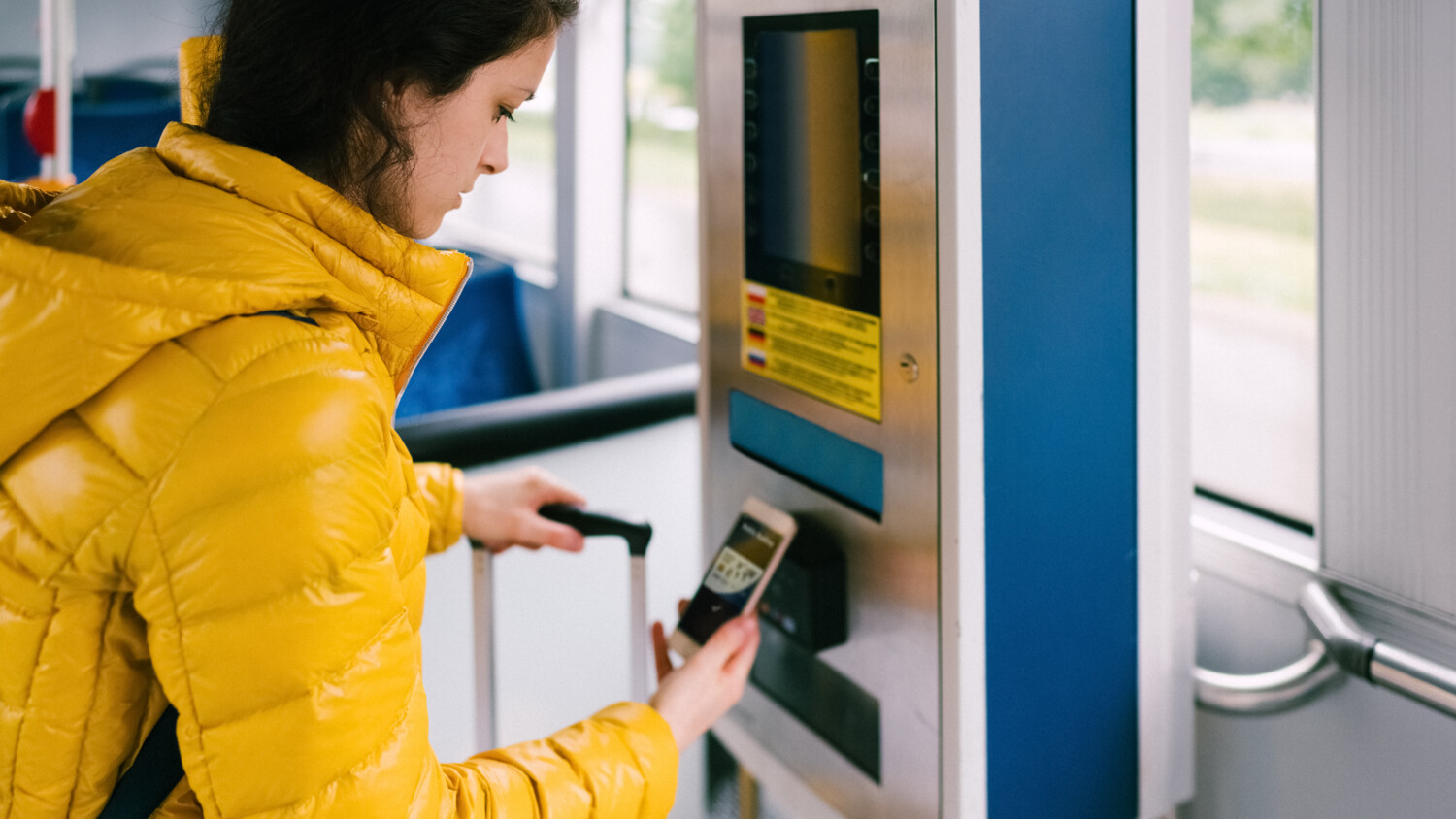 Person paying ticket with mobile phone.