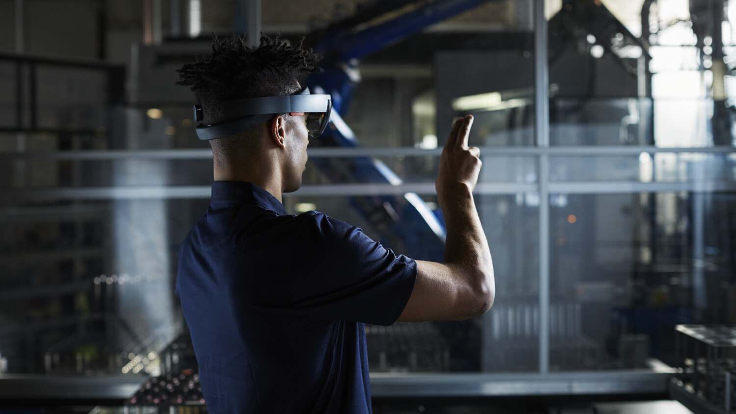 Man in robot factory using AR