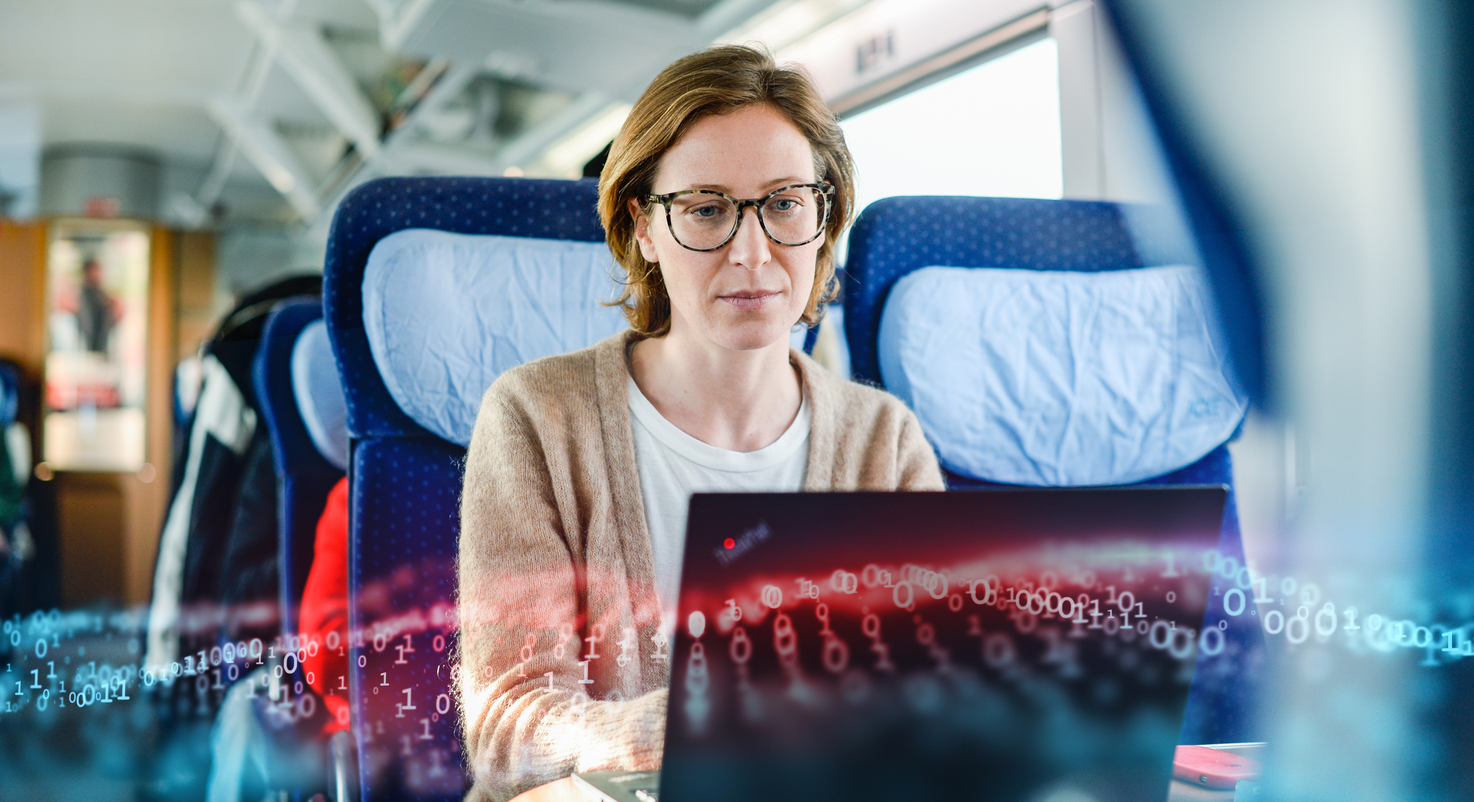 Woman working on a laptop in the train.