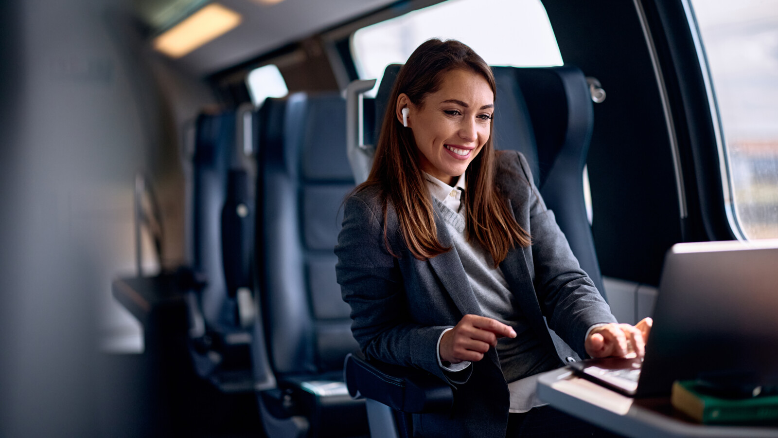 Woman using her computer on a train.