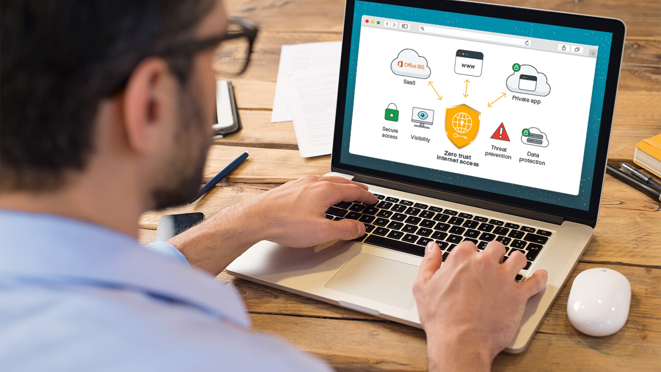 A man is looking at a web application on a laptop.