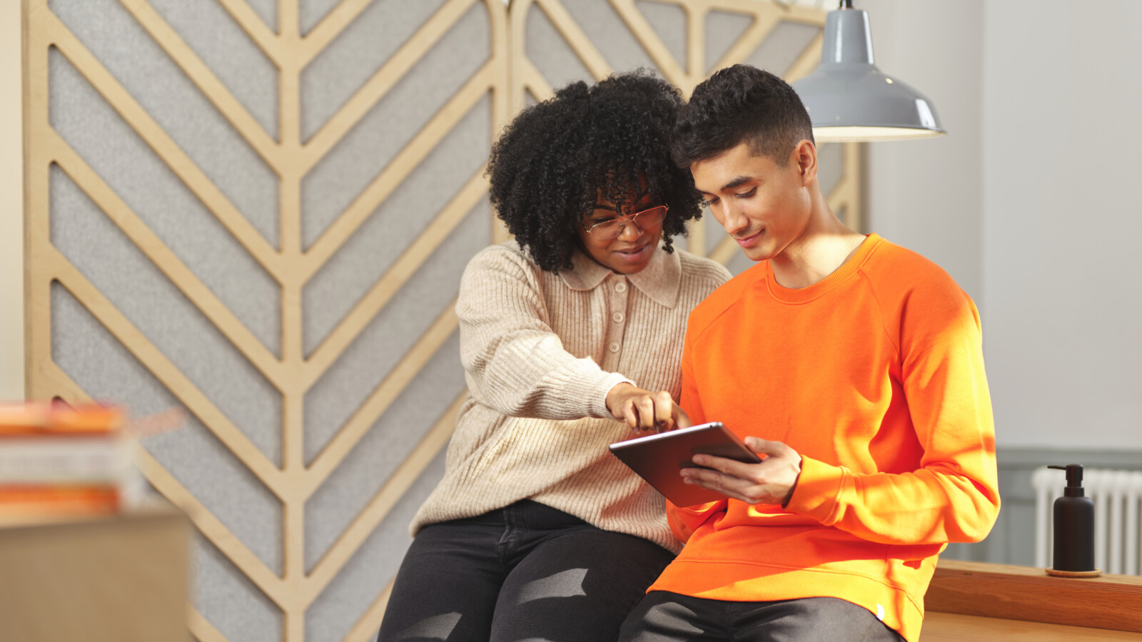 Colleagues discussing information on a tablet.