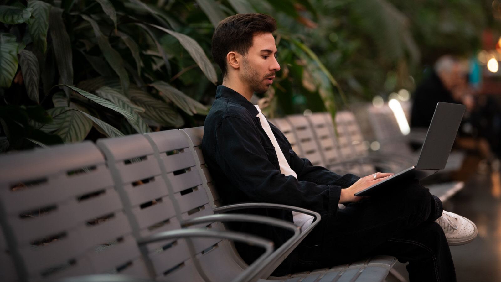Man using his laptop outdoors.