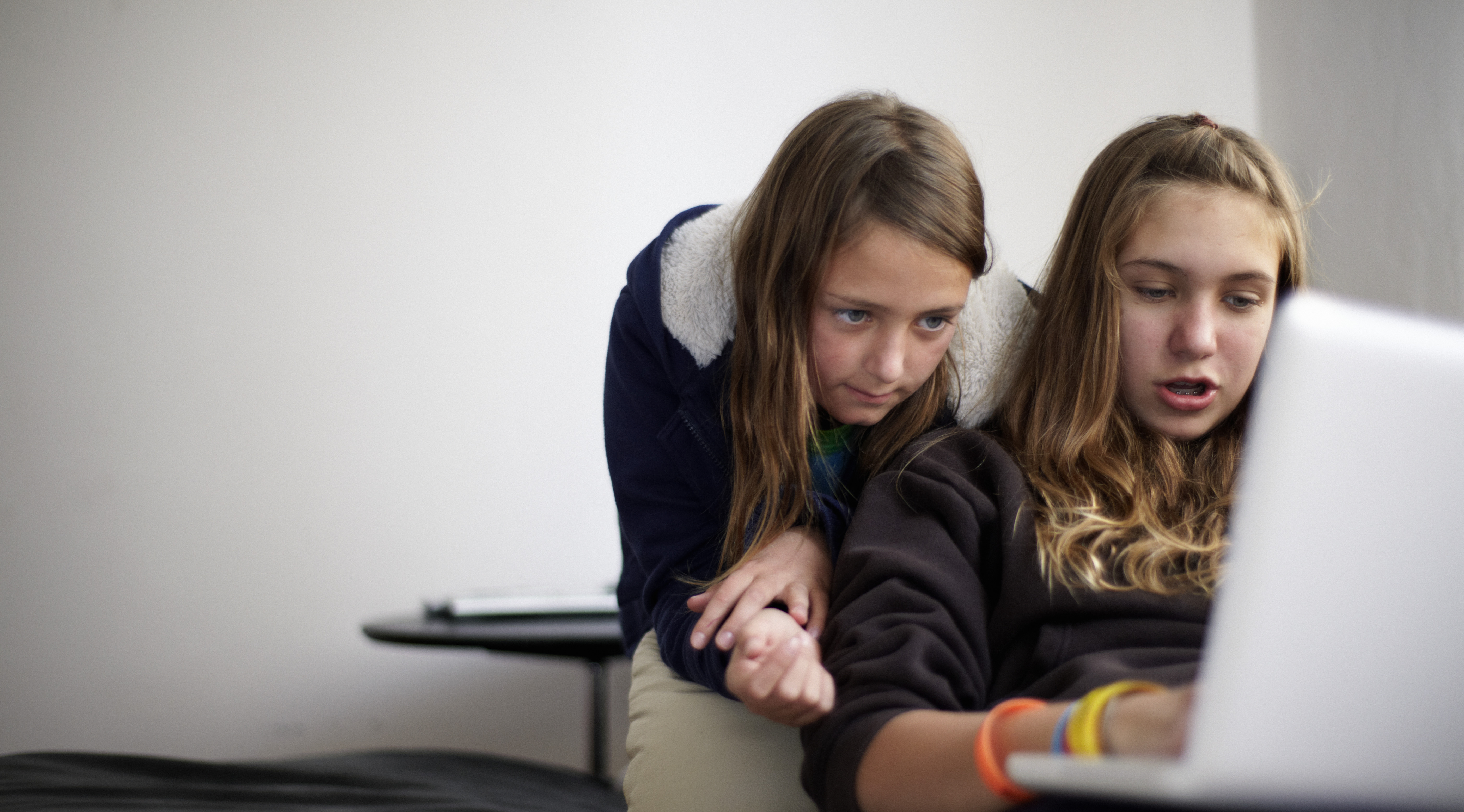 Girls looking at a laptop.