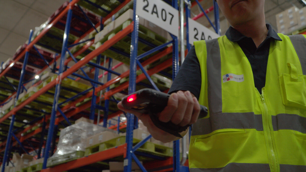 Person scanning in a warehouse center.