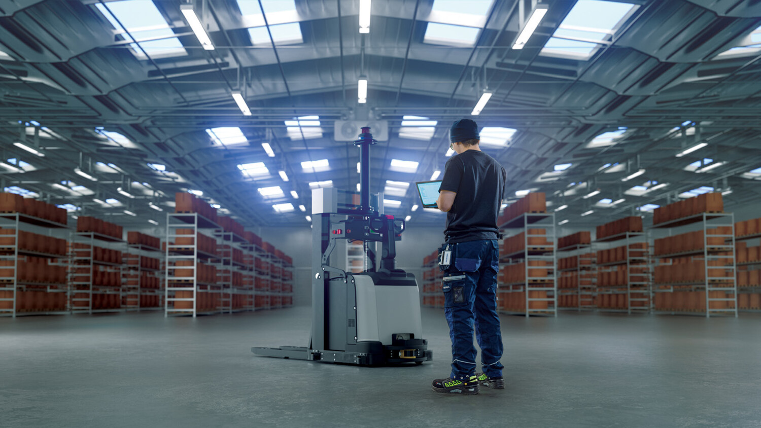 Person with tablet in a warehouse.