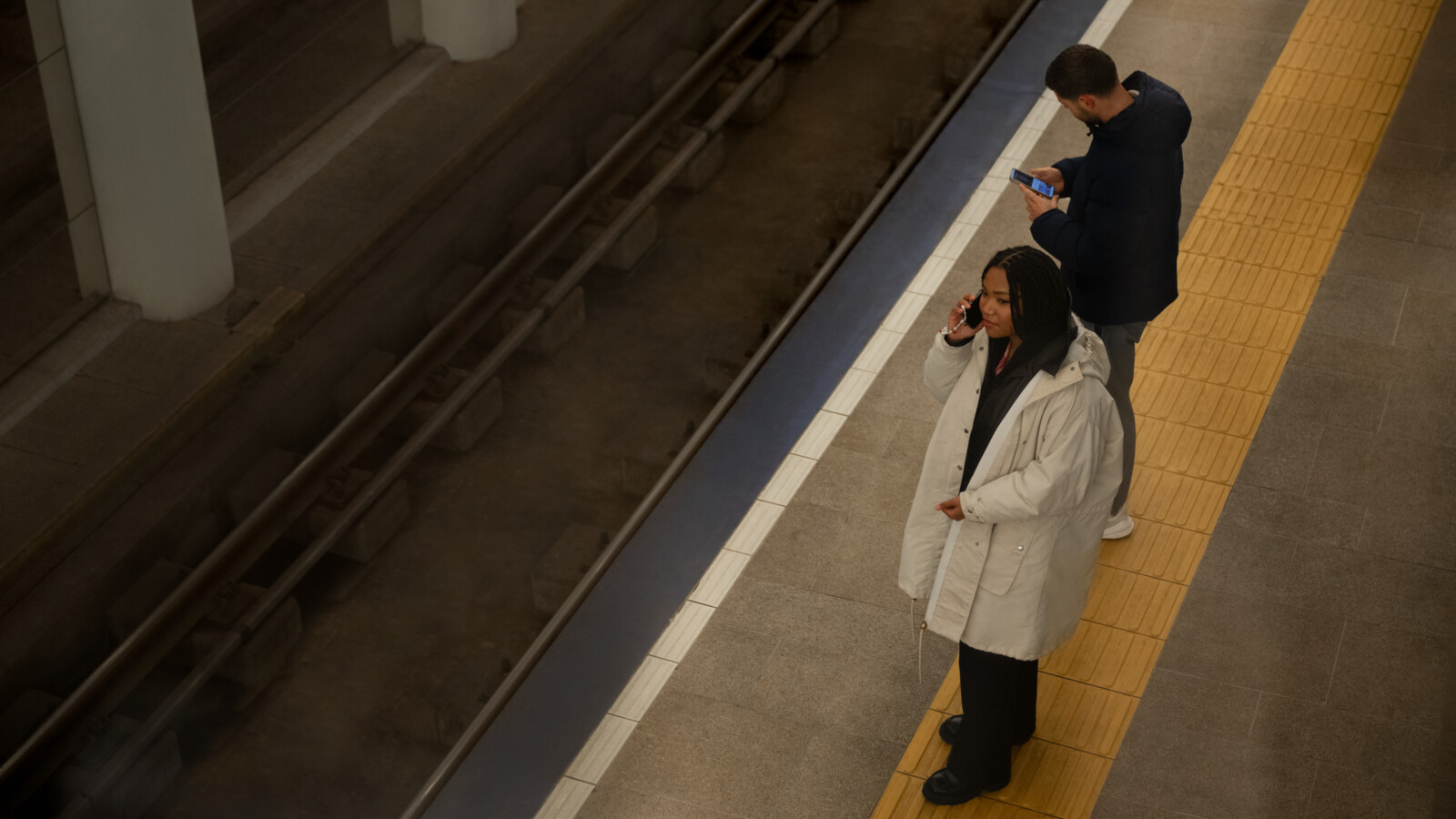 Woman talking on the phone at public transport station