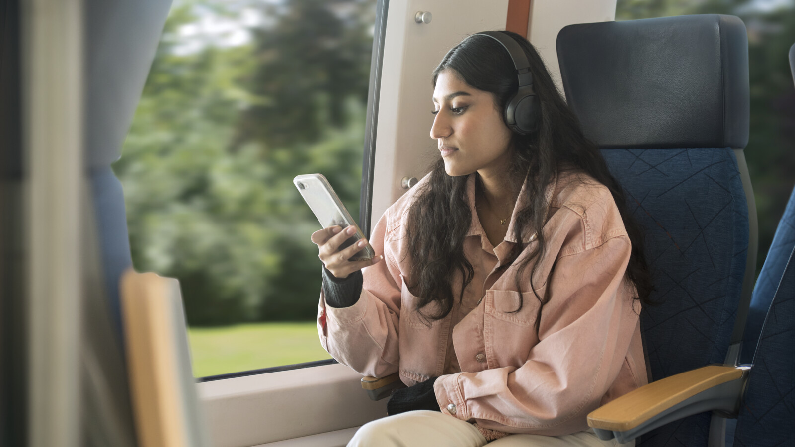 Woman using her mobile device on a train.