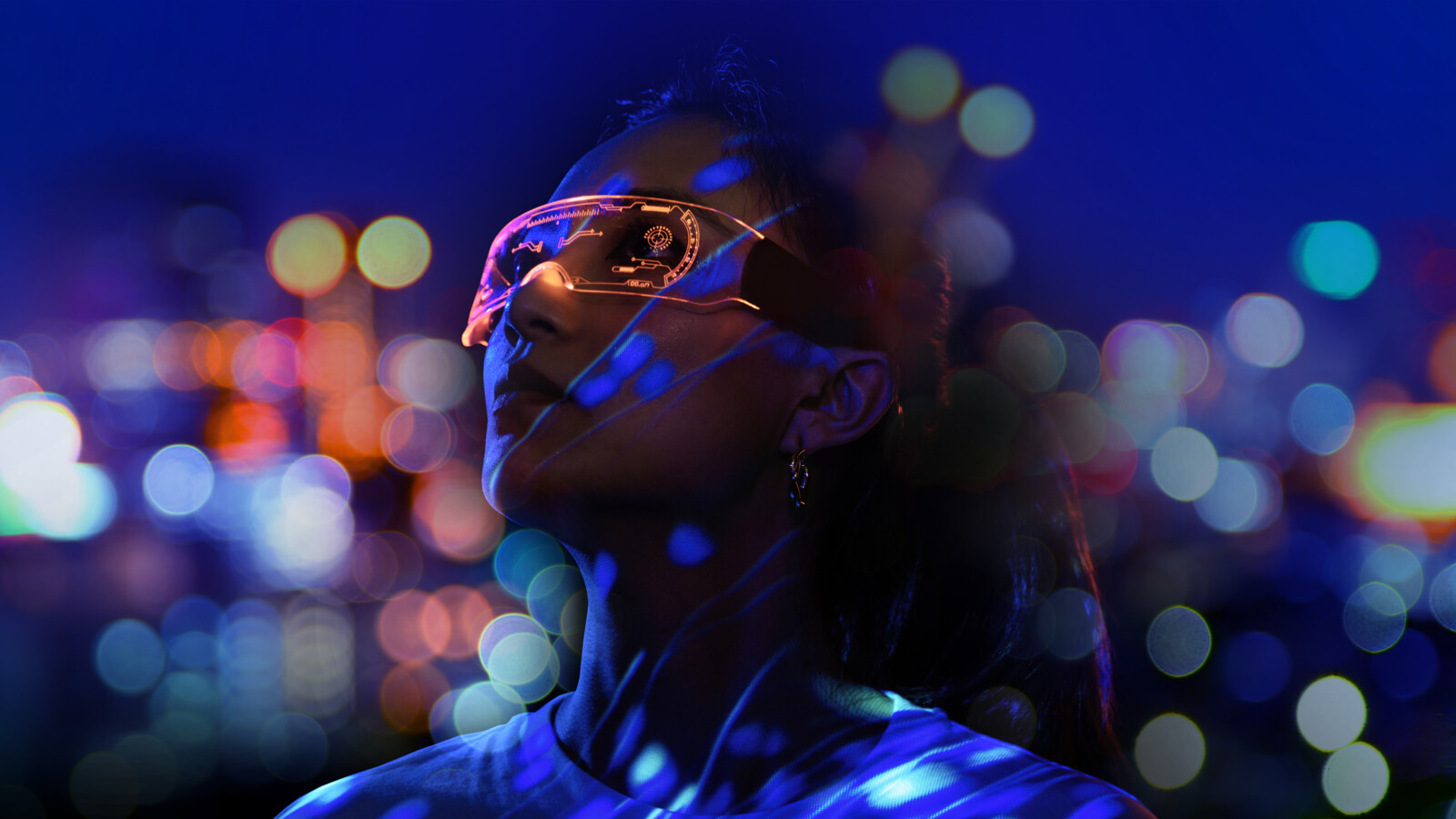 Person with a VR headset and city lights behind.