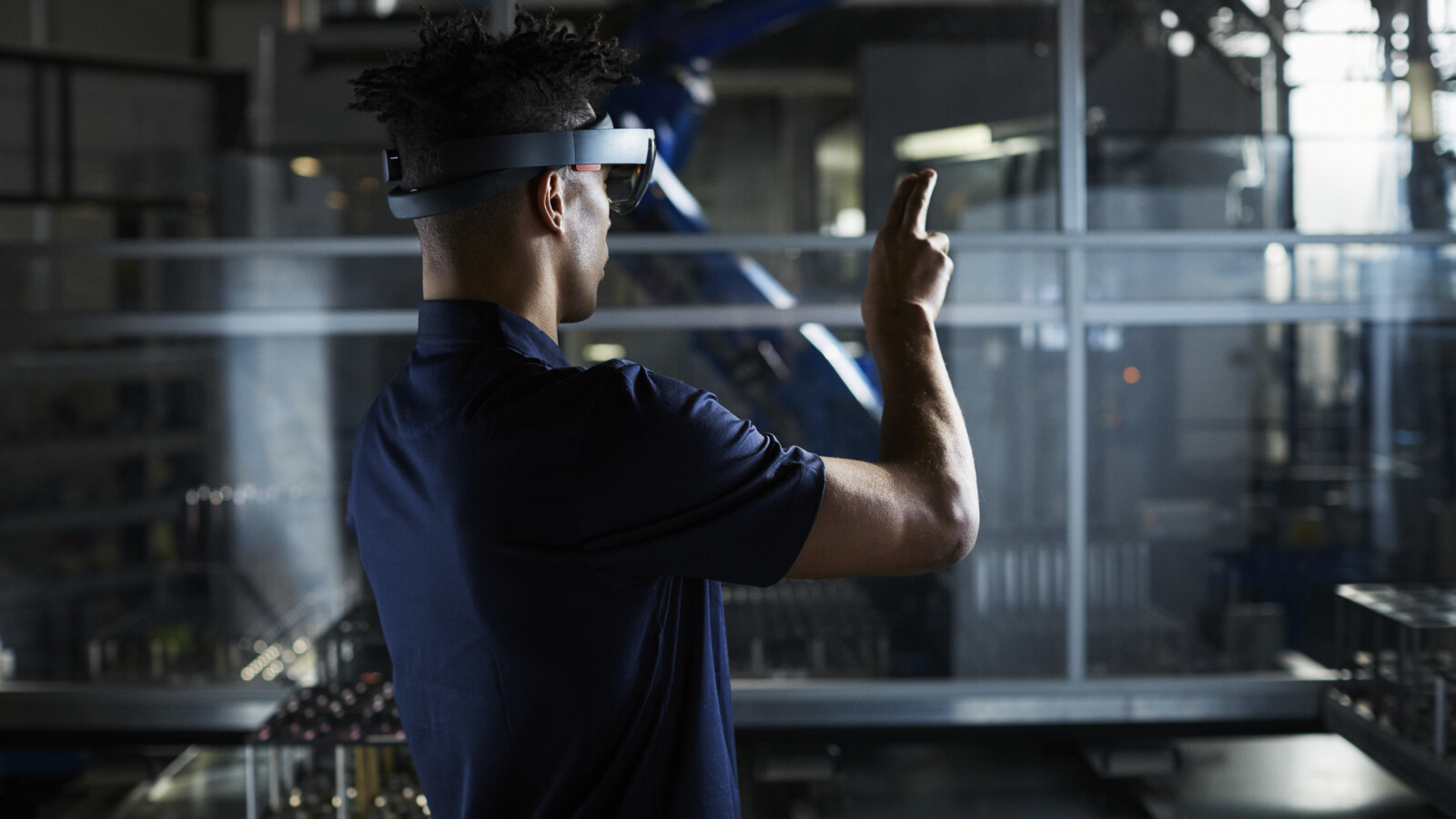 Man in robot factory using AR.