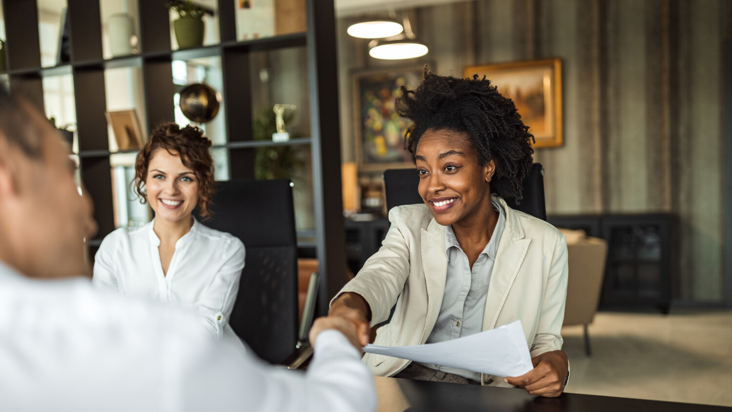 Two persons shaking hands.
