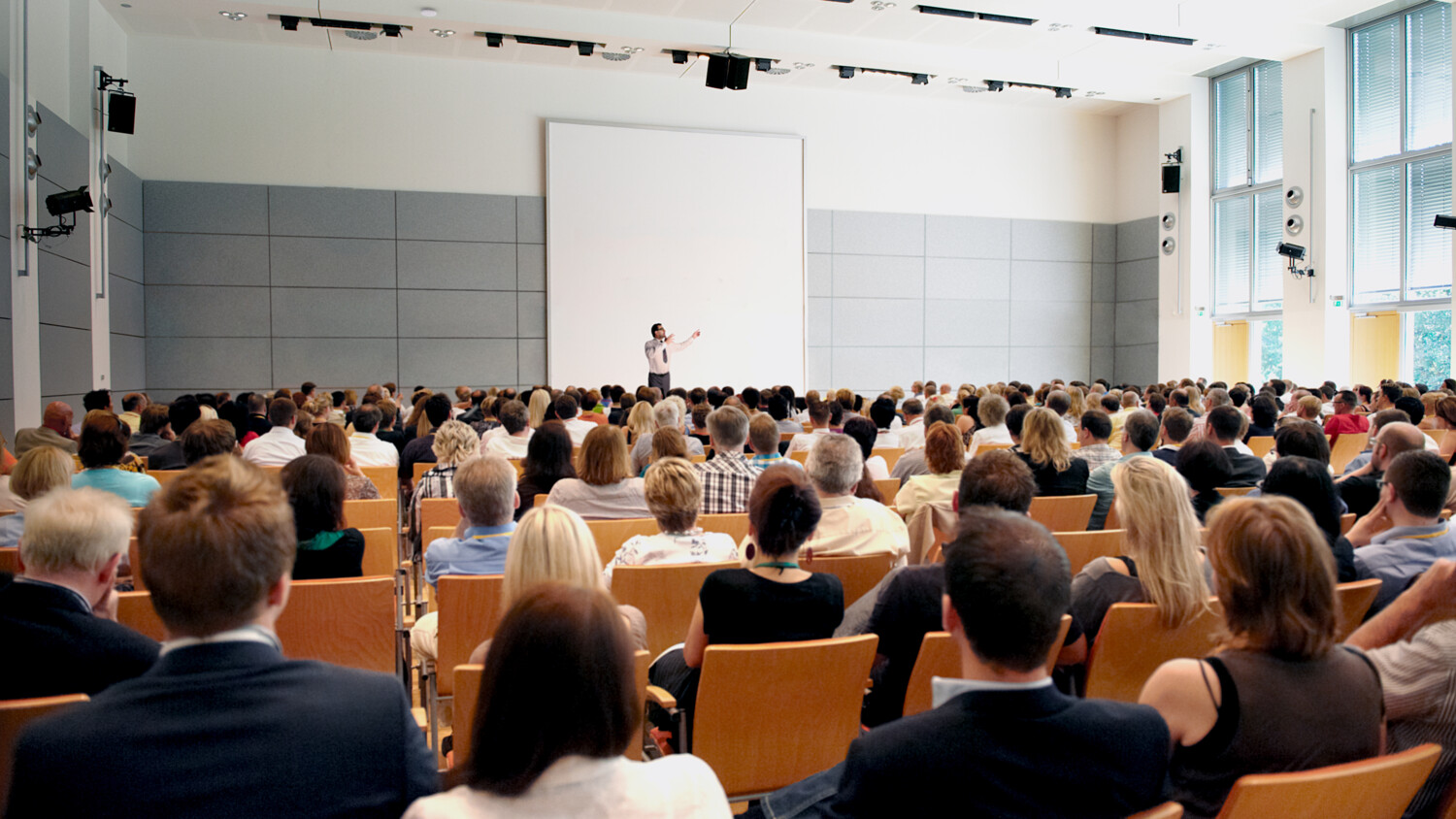 A man on stage in front of an audience.