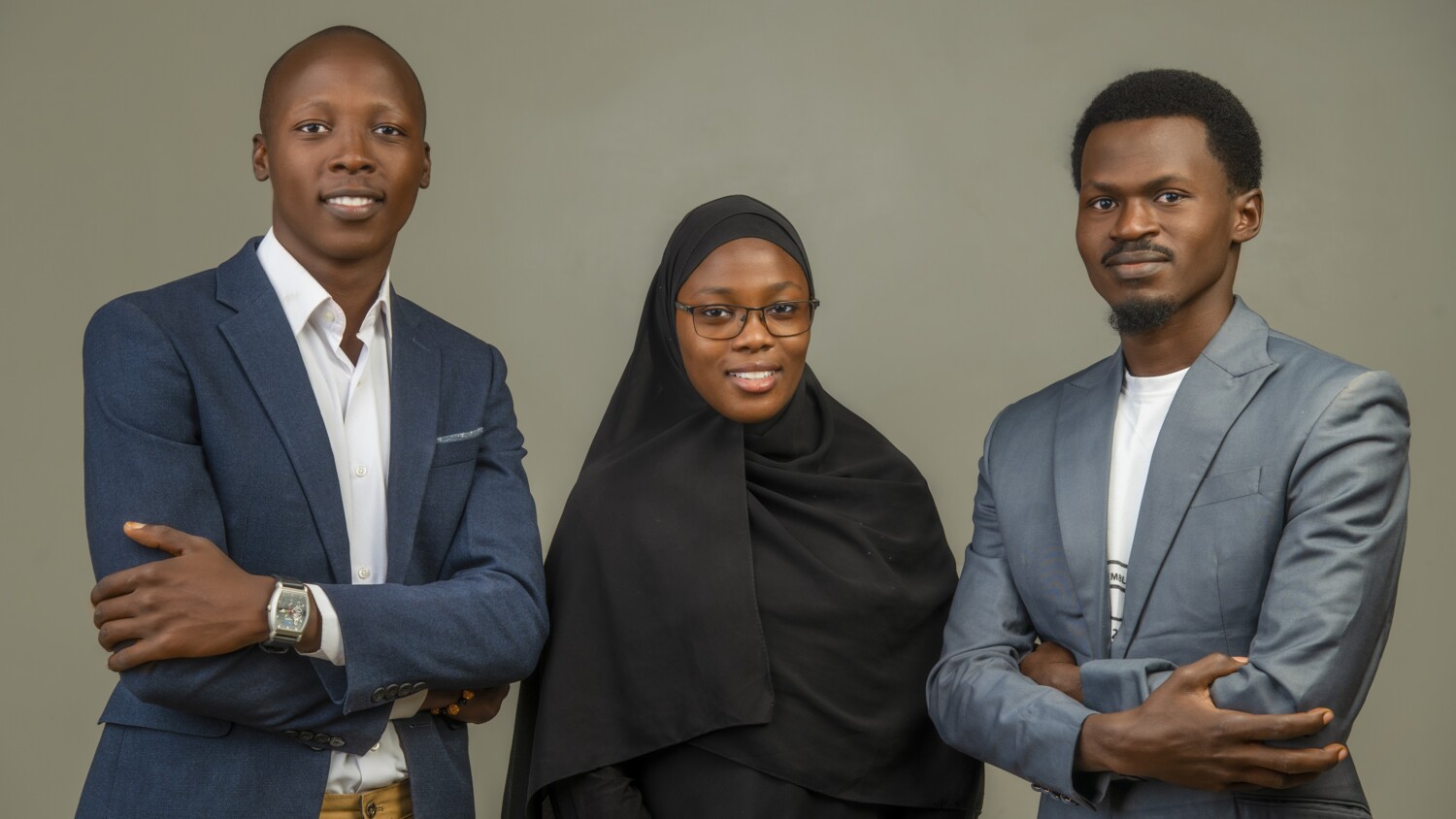 Three people standing and looking at camera