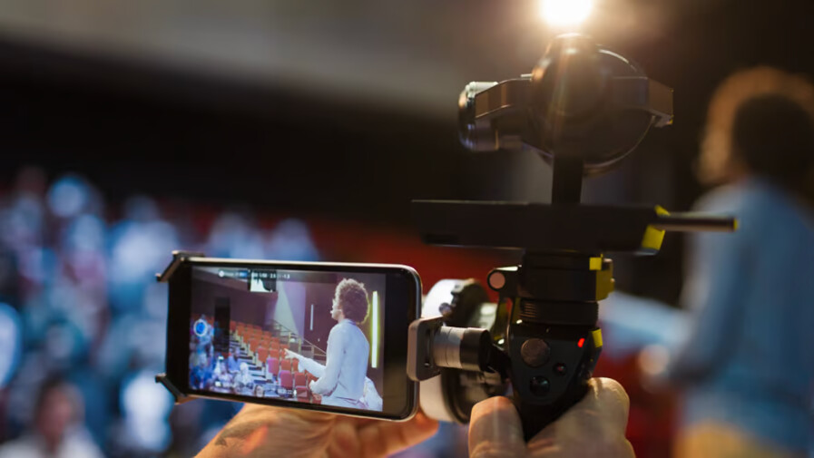 Person filming with mobile phone